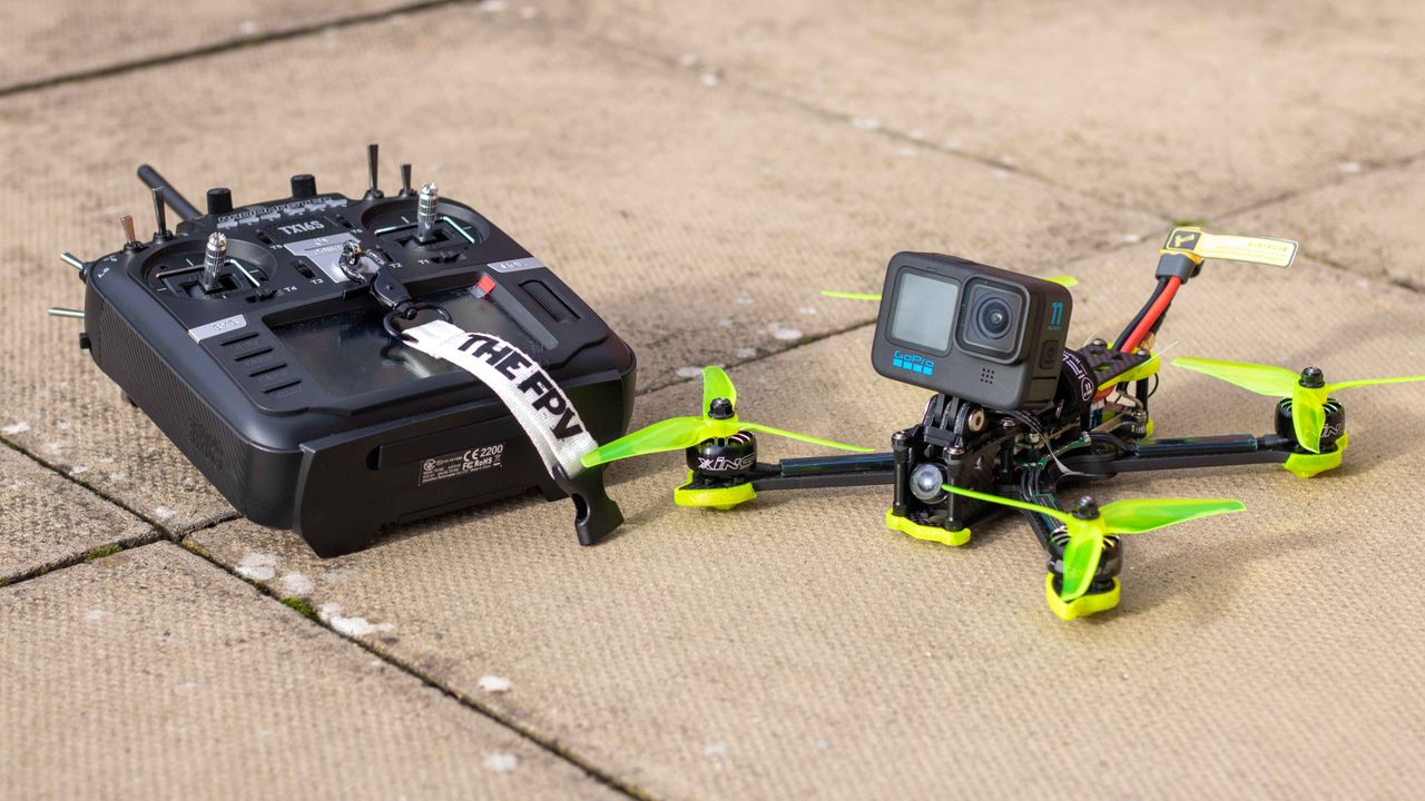 A custom FPV drone with an action camera and its transmitter