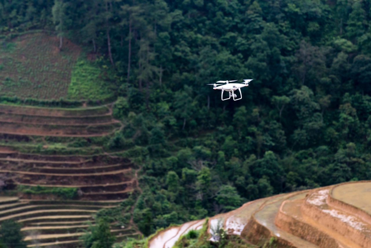 A drone flying over terraced fields